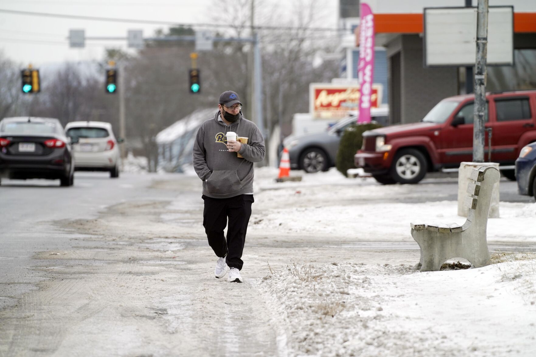 Man walks on road to avoid ice